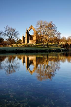 Ruins of Bolton Abbey, seen reflected in water