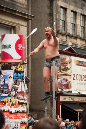 Knife juggler at top of ladder in Edinburgh Festival