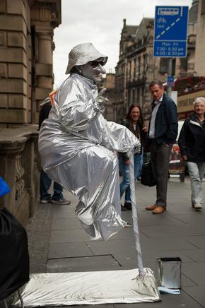 Street performer doing balancing act on the Royal Mile