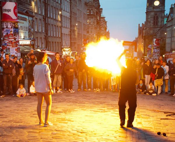 Fire Eater swinging flaming batons