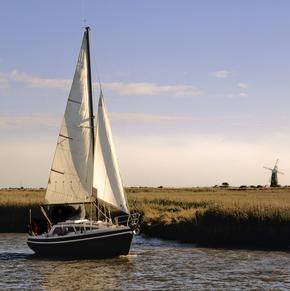 Boat sailing on the river waveney past the berny arms mill