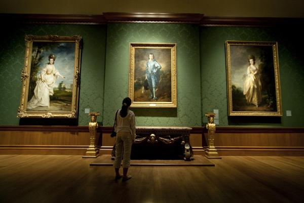 A visitor admires 'The Blue Boy' by Thomas Gainsborough