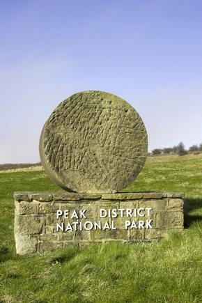 Millstone at entrance to Peak District National Park