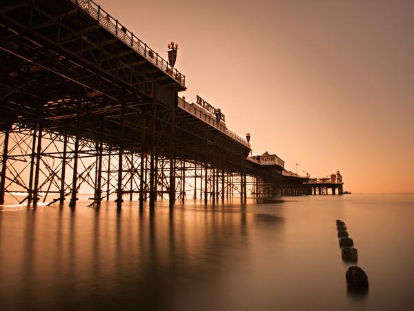 © Shutterstock / piotreknik Brighton Pier viewed from below at sunset