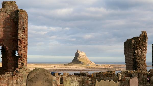 Lindisfarne Castle seen from the graveyard of Lindisfarne Priory.