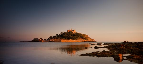 St Michael's Mount, Marazion, Cornwall bathed in light of orange sunset