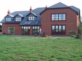 Kiddicott Farm house overlooking the gardens.