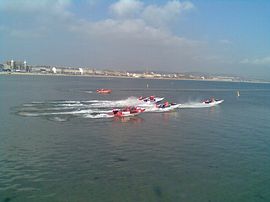 Powerboats race in front of Aaran House