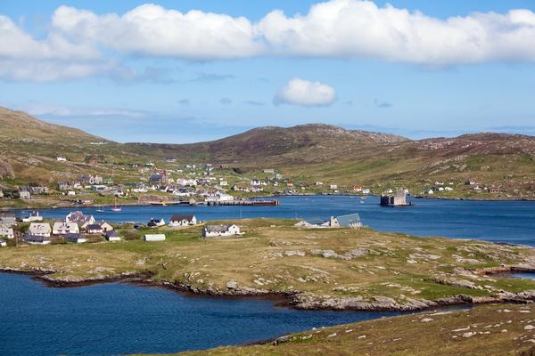 Panoramic view of Castlebay, Barra ©Shutterstock / Andrea Ricordi Panoramic view of Castlebay, Barra, Outer Hebrides showing houses scattered across the landscape Kisimul Castle