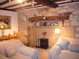 Beamed sitting room, feature fireplace   