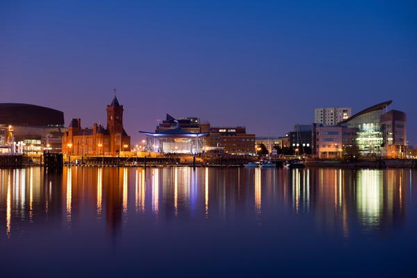 Cardiff Bay at night with lights reflecting in the sea
