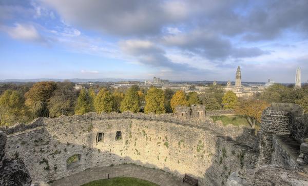 Walls of Cardiff Castle with view to city in the distance