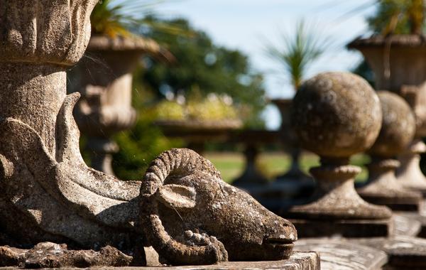 Stone sculpure of a ram at the base of a pot, in the royal gardens of Osborne House