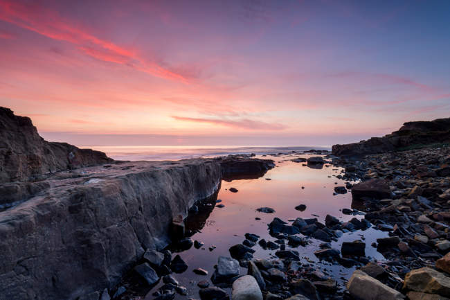 Sunrise and dawn light over the rocks on Cresswell Beach