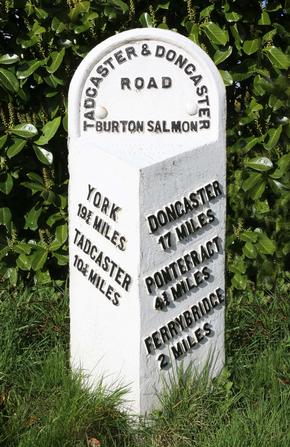 Old British road milestone showing distances to York and Tadcaster, Ferrybridge, Pontefract and Doncaster.